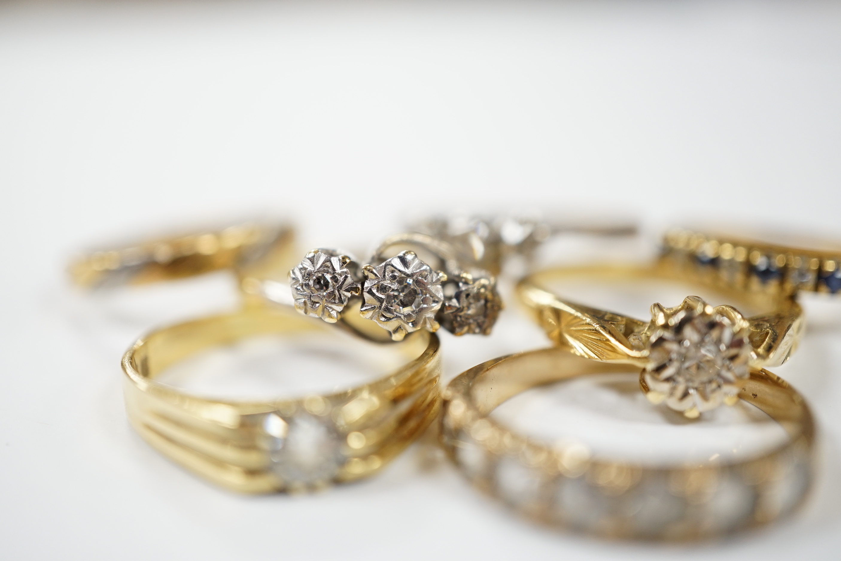 A 1920's 18ct gold and claw set solitaire diamond ring, size O, five other assorted 18ct gold and gem set rings including diamond, together wit a yellow metal and paste set half hoop ring, gross weight 17.2 grams.